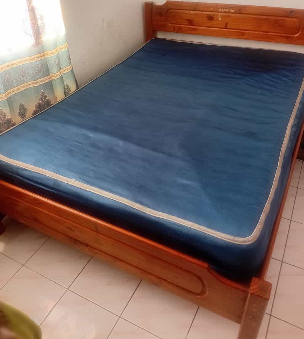 Wooden Bed Frame with Blue Mattress